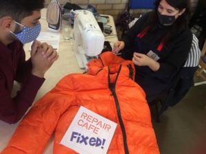People fixing a coat